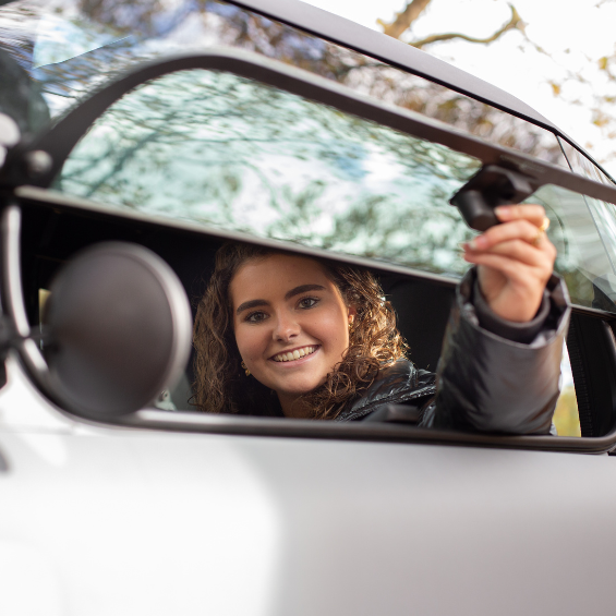 Lieke die het raam opent in de Opel Rocks